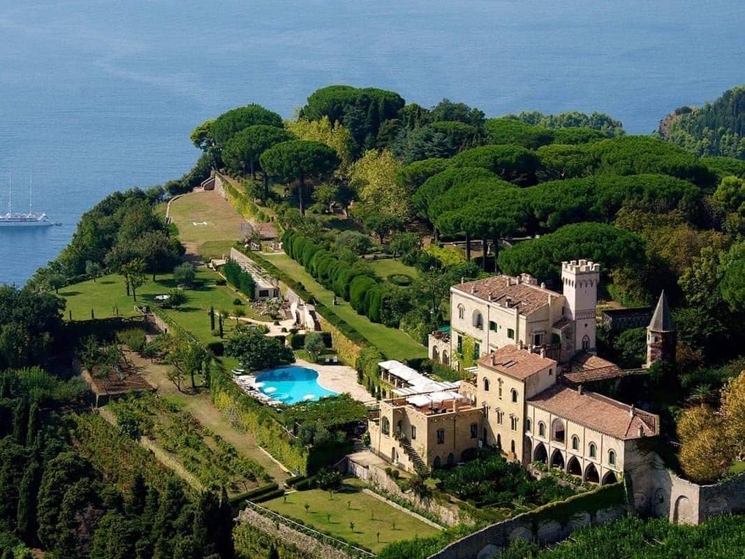 Aerial view of Villa Cimbrone in Ravello, Italy.  Photo shows the villa in the bottom right of the picture with the park and woodland above and to the left.  The sea can be seen in the top right of the picture.
