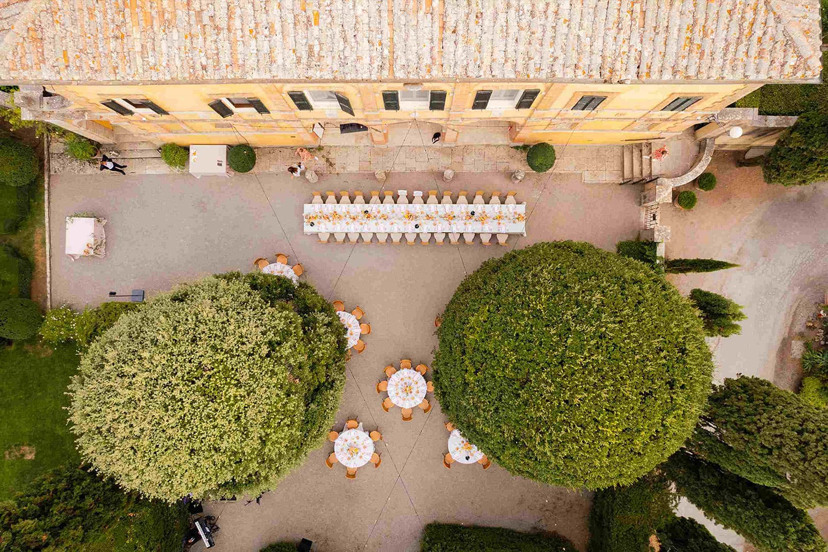 Drone photo showing wedding banquet set-up at La Foce wedding venue near Siena in Tuscany, Italy.