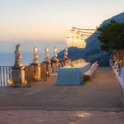 Long dining table set p on a terrace in Ravello high above the sea.