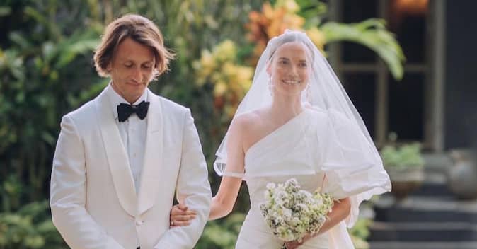 well dressed couple walk down the aisle at a stylish Italian wedding