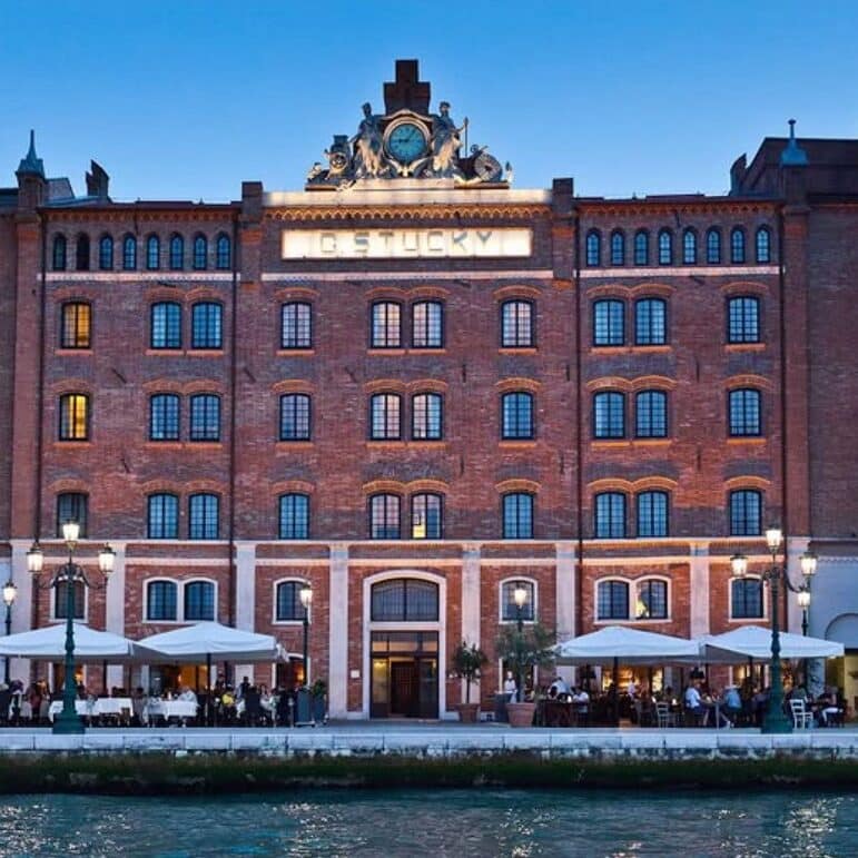 Large red brick palace in Venice, photographed across the water.