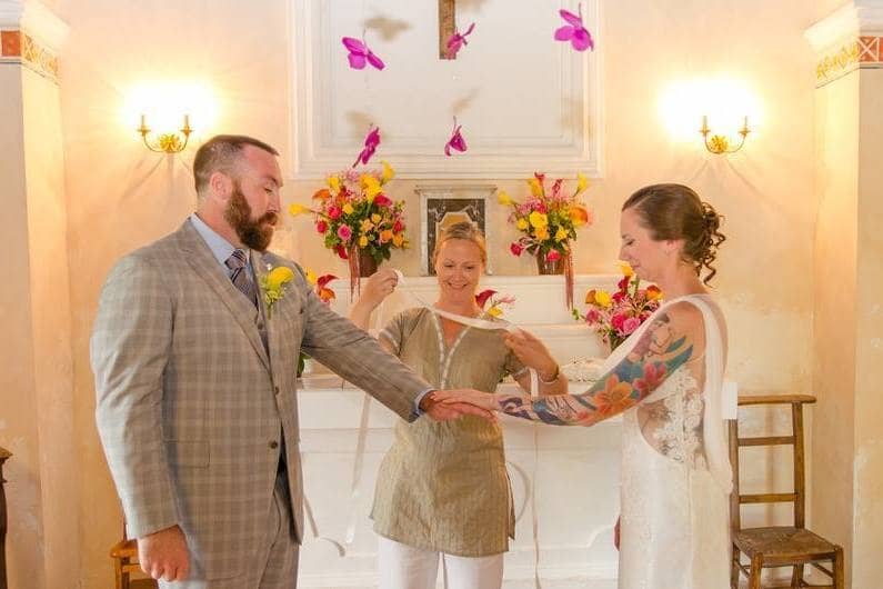 Will and Courtney hold hands at their wedding ceremony