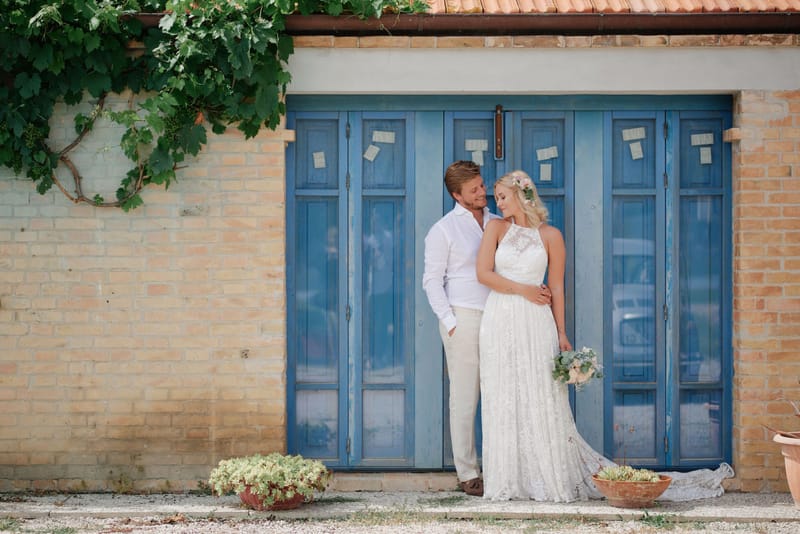 bride and groom pose for a photograph